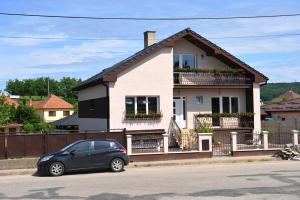 a small car parked in front of a house at Vila Václav in Podhájska