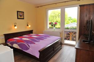 a bedroom with a large bed and a window at Vila Václav in Podhájska