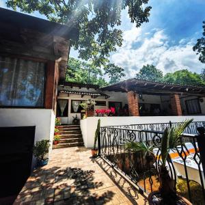 a house with a gate and stairs to a porch at Don Polo casaboutique in Valle de Bravo