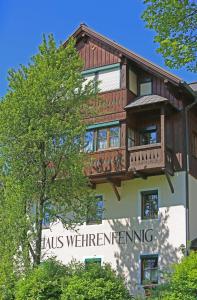 a building with a balcony on top of it at Appartementhaus Wehrenfennig in Gosau