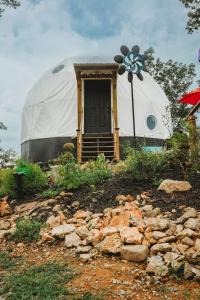 a yurt with a door and a flower on it at WATERFRONT LUXURY GLAMPING DOME in Rogersville