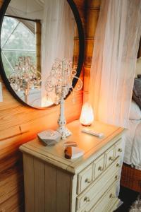 a dressing table with a mirror on top of a dresser at WATERFRONT LUXURY GLAMPING DOME in Rogersville