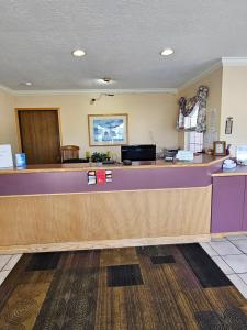 a waiting area of a waiting room with a counter at Great Lakes Inn Mackinaw City in Mackinaw City