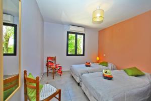 a bedroom with two beds and a table and chairs at GITE DE 6 A 14 PERSONNES Chez Léontine in Lacave