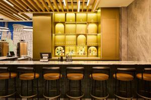 a bar in a restaurant with stools at Delta Hotels by Marriott New York Times Square in New York