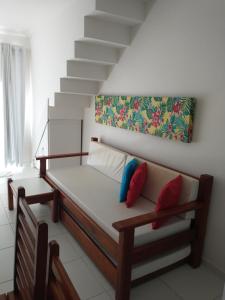 a bed with two pillows on it in a room at Recanto Taperapuan Residencial Mont Carmelo in Porto Seguro