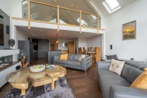 a living room with a couch and a table at Pendle View by Valley View Lodges in Longridge