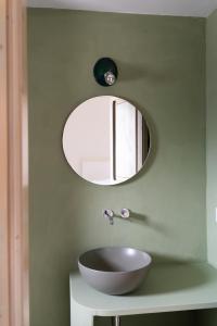 a bathroom with a bowl sink and a mirror at Masseria Gorgognolo in Ostuni