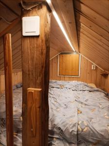 a bedroom with a bed in a wooden cabin at Ljungdahl in Korppoo
