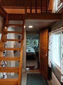 a small room with a bunk bed in a tiny house at Ljungdahl in Korppoo