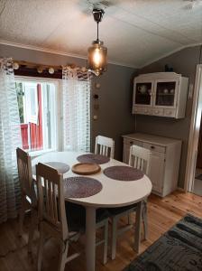 a kitchen with a table and chairs in a room at Ljungdahl in Korppoo