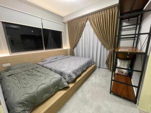 a bedroom with a bed and a large window at Imperio Residence Melaka - Private Jacuzzi with Seacityview stay with Wifi in Melaka +26 photos