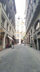 an empty street in a city with tall buildings at Sugar House City Center Apartment in Budapest