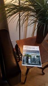a newspaper sitting on a table next to a table at Sugar House City Center Apartment in Budapest