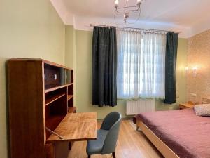 a bedroom with a bed and a desk with a television at Lielbornes Muiža Boutique Hotel&Recreation Complex in Lielborna