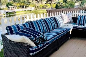 a blue and white couch sitting on a deck at Lake front house 4 beds 3baths in Agoura Hills