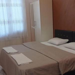 A bed or beds in a room at Mardin Expert Otel