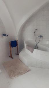 uma casa de banho branca com uma banheira e um lavatório em Apartmán v koňském areálu Židovice em Louny