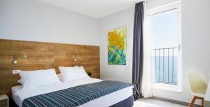 Posteľ alebo postele v izbe v ubytovaní Hotel Štacija