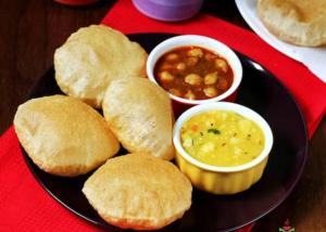 a plate of food with biscuits and soup on a table at Goroomgo Kanha Inn Lucknow in Lucknow