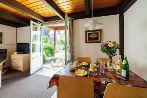 a dining room with a table with chairs and a dining room at Apartments home Atlanta Pellworm - DNS10029-CYA in Waldhusen