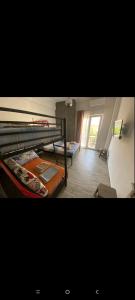 a room with two bunk beds and a window at Victoria Loutraki Лутраки apartment in Loutraki