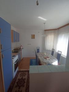a kitchen with a table and a dining room at Sleep & fly - Single room with shared bathroom in Sarajevo