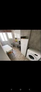 a small kitchen with a stove and a sink at Victoria Loutraki Лутраки apartment in Loutraki