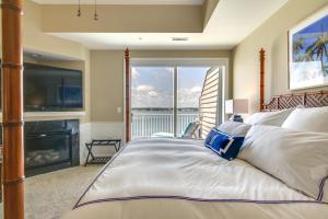 a bedroom with a bed with a fireplace and a television at Ocean City Condo with Panoramic Views Walk to Beach in Ocean City