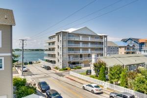 an apartment building on a street with cars parked at Ocean City Condo with Panoramic Views Walk to Beach in Ocean City