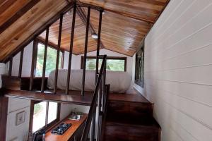 a bedroom in a tiny house with a bed at Tiny House Villa... in Santa Cruz