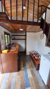 a room with a kitchen and a bed in a house at Tiny House Villa... in Santa Cruz