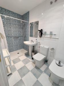 a bathroom with a toilet and a sink at MEDA Padrón in Padrón +23 photos