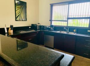 a kitchen with a counter top and a sink at Sublime Villa in the Heart of Playa Coronado in Playa Coronado