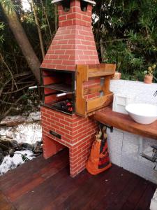 a brick oven sitting on top of a deck at Pousada Canto Feliz in Serra do Cipo