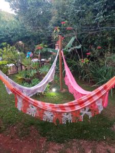 a hammock in the middle of a garden at Pousada Canto Feliz in Serra do Cipo