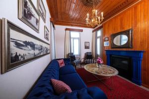 a living room with a blue couch and a fireplace at Hotel Bosnali in Adana