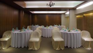 a conference room with white tables and chairs at The Mirador Andheri East in Mumbai