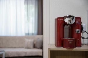 a red mixer sitting on a table next to a couch at Euaggelias & Cristianas House in Aristi