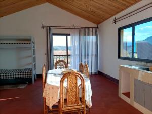 a dining room with a table and chairs and a window at Maison d'hôtes Akany Fifaliana in Antananarivo