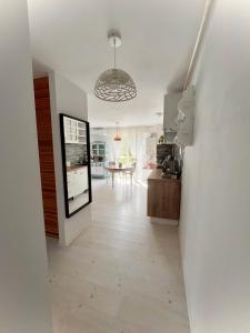 a hallway with a kitchen and a dining room at The Airport Loft in Otopeni