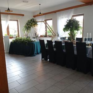 a room with two tables and chairs and a table set up at Ośrodek Wczasowy "Wczasy pod gruszą" in Biecz