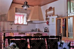 a kitchen with a sink and a refrigerator at Casa do Loureiro in Ferrarias +6 photos
