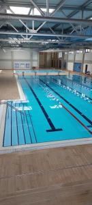 a large swimming pool in a large building at Apartman Luxor in Jagodina