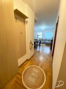 a hallway with a door with a sign that reads your next home at D Apartment Free private Parking in Novi Sad