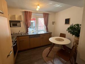 a kitchen with a table and a small table at Graz City Centre Apartment 12 in Graz