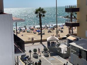 a view of a beach with a crowd of people at Vistas al mar a 10 metros de la Playa de Regla PARKING GRATIS in Chipiona