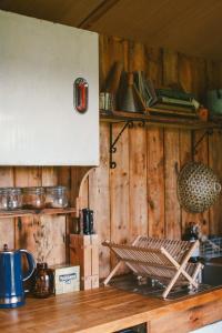 a kitchen with wooden walls and a wooden counter top at Infinite Skies Tipi's in Heydon