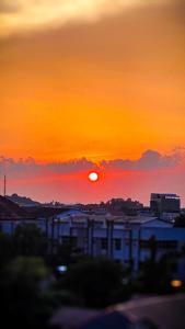 a sunset over a city with the sun in the sky at Japanese Zen Room Citra Plaza Nagoya Batam in Nagoya