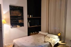 a bedroom with a bed and a painting on the wall at Le petit Faure - Appartement 4 pers - Part-Dieu in Lyon